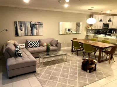 a living room with a couch and a table at NEW Home 3 Bedrooms Water View Disney Universal in Kissimmee