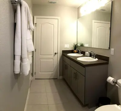 a bathroom with two sinks and a mirror at NEW Home 3 Bedrooms Water View Disney Universal in Kissimmee