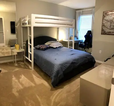 a bedroom with a bunk bed and a desk at NEW Home 3 Bedrooms Water View Disney Universal in Kissimmee