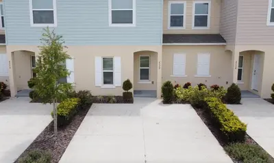 a house with a driveway in front of it at NEW Home 3 Bedrooms Water View Disney Universal in Kissimmee