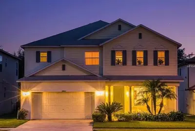 a house with a garage in front of it at Relaxing Villa near the Parks! in Orlando