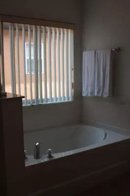 a bath tub in a bathroom with a window at Relaxing Villa near the Parks! in Orlando