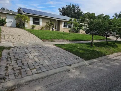 a brick driveway in front of a house at Paradise Apartment in Orlando