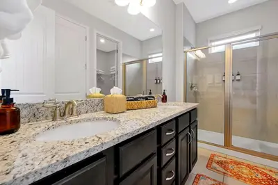 a bathroom with a sink and a shower at Family Escape | Moana Vibes | Pool + Games in Orlando