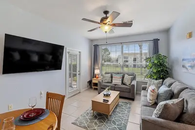 a living room with a couch and a table at 2302 Butterfly Palm 102 in Kissimmee