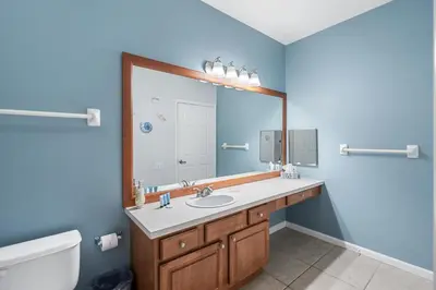 a bathroom with a sink and a mirror at 2302 Butterfly Palm 102 in Kissimmee