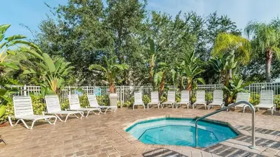 a group of chairs and a swimming pool at 2302 Butterfly Palm 102 in Kissimmee