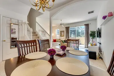 a dining room with a table and chairs at 10 Mi to Disney World Townhome with Community Pool! in Kissimmee