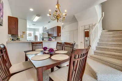 a kitchen and dining room with a table and chairs at 10 Mi to Disney World Townhome with Community Pool! in Kissimmee