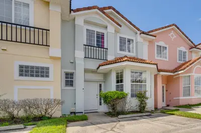 a row of houses with a driveway at 10 Mi to Disney World Townhome with Community Pool! in Kissimmee
