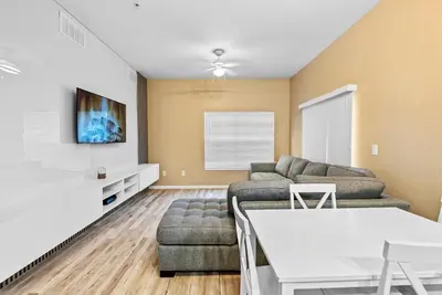 a living room with a couch and a table at Cozy Themed 04 bedrooms - Close to Disney in Kissimmee
