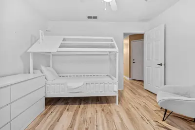 a white bedroom with a white bunk bed at Cozy Themed 04 bedrooms - Close to Disney in Kissimmee