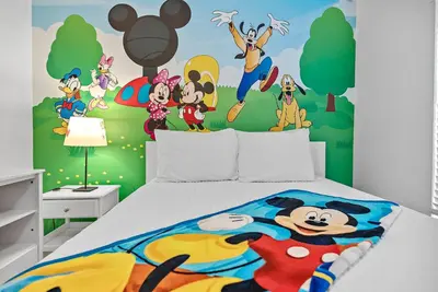 a bedroom with a bed with a disney mural at Cozy Themed 04 bedrooms - Close to Disney in Kissimmee