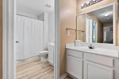 a bathroom with a white sink and a toilet at Cozy Themed 04 bedrooms - Close to Disney in Kissimmee