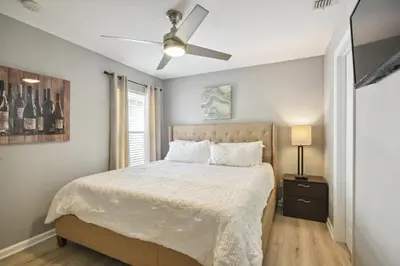 a bedroom with a bed with a ceiling fan at Paradise Villa in Orlando