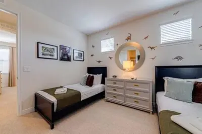 a bedroom with a bed and a dresser and a mirror at RVH7391 - Five Bed Luxury Disney Vacation Retreat in Orlando