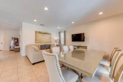 a dining room with a table and chairs and a couch at RVH7391 - Five Bed Luxury Disney Vacation Retreat in Orlando