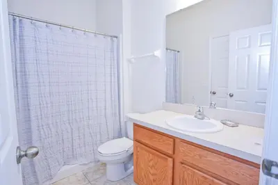 a bathroom with a toilet and a sink and a shower at Plunge Pool Oasis Bella Vida Resort Close to Parks in Kissimmee