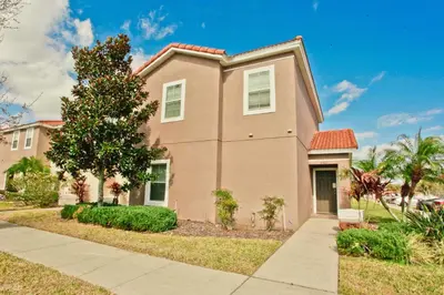 a house with a tree and a sidewalk at Plunge Pool Oasis Bella Vida Resort Close to Parks in Kissimmee