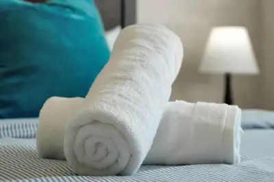 a rolled up towel on top of a bed at Family Pool Villa I Near Disney I 2 Free Clubhouses in Kissimmee