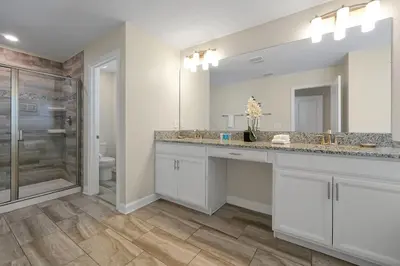 a bathroom with two sinks and a shower at Family Pool Villa I Near Disney I 2 Free Clubhouses in Kissimmee