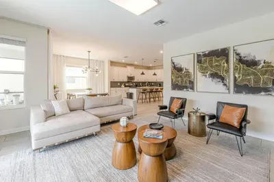 a living room with a couch and tables and chairs at 2807 - Storybook Escape in Kissimmee