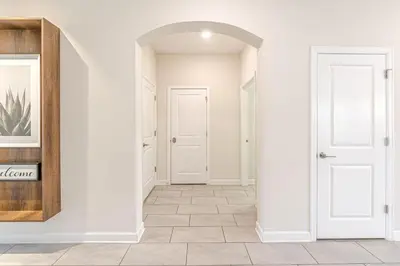 an empty hallway with white walls and white doors at 2807 - Storybook Escape in Kissimmee