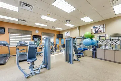 a gym with cardio equipment and balloons in the middle at Floridays Resort Condo 11 Mi to Walt Disney World! in Orlando