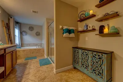 a bathroom with a shower and a tub at NEW, Disney,10mi, Themed Rooms, PvtPool, Movie, Game Room in Kissimmee