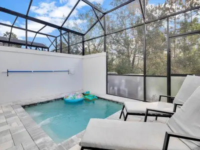 a swimming pool in a house with a glass ceiling at TR17226BD - 4 bedr w/pool - 10 guests Near Disney in Orlando