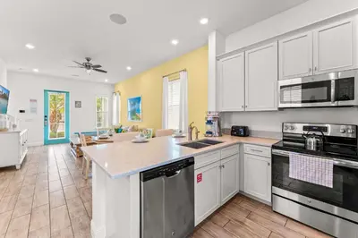 a kitchen with white cabinets and a counter top at Savannah Daydreamin - For 6 in Orlando