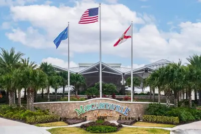 a sign with three flags in front of a building at Savannah Daydreamin - For 6 in Orlando