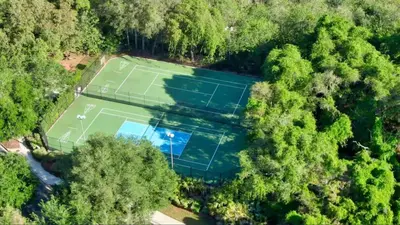 an overhead view of two tennis courts in a forest at Magic Getaway at Emerald Island in Kissimmee