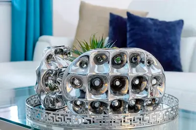 a glass bowl filled with wine bottles on a table at 2616 TRANQUILITY KISSIMMEE 6 BED in Kissimmee