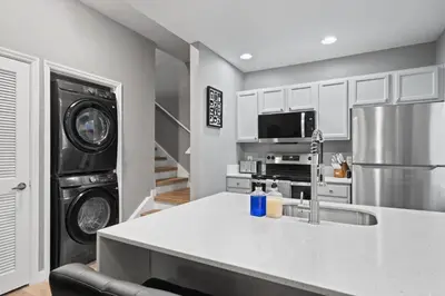 a kitchen with a sink and a washer and dryer at 4 Bedroom 3 Bathroom Villas At Seven Dwarfs 18-108 in Kissimmee