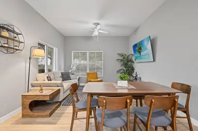 a dining room and living room with a table and chairs at 4 Bedroom 3 Bathroom Villas At Seven Dwarfs 18-108 in Kissimmee