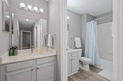 a white bathroom with a sink and a toilet at 4 Bedroom 3 Bathroom Villas At Seven Dwarfs 18-108 in Kissimmee