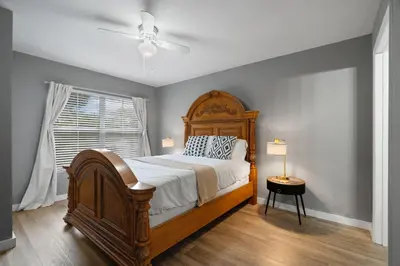 a bedroom with a large bed and a window at 4 Bedroom 3 Bathroom Villas At Seven Dwarfs 18-108 in Kissimmee