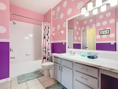 a pink and purple bathroom with a sink and a toilet at Windsor Hills Magical Condo Pool Slides By Disney in Orlando