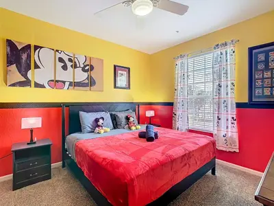 a bedroom with a red bed with two stuffed animals on it at Windsor Hills Magical Condo Pool Slides By Disney in Orlando