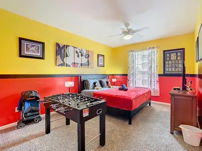 a bedroom with a bed and a foosball table at Windsor Hills Magical Condo Pool Slides By Disney in Orlando