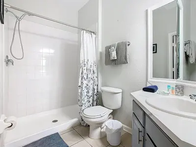 a white bathroom with a toilet and a sink at Windsor Hills Magical Condo Pool Slides By Disney in Orlando