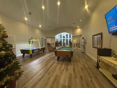 a living room with pool tables and a christmas tree at 3 Bedroom 2 Bathroom Villas At Seven Dwarfs 20-104 in Kissimmee