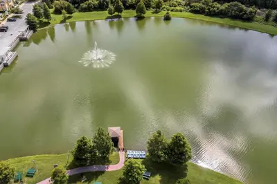 an aerial view of a large lake with a fountain at 3 Bedroom 2 Bathroom Villas At Seven Dwarfs 20-104 in Kissimmee