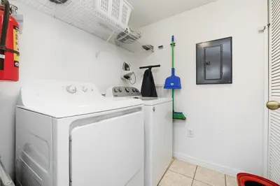 a white laundry room with a washer and dryer at Resort stay Pool Access Peaceful Retreat Balcony in Kissimmee