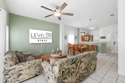 a living room with couches and a dining room at Resort stay Pool Access Peaceful Retreat Balcony in Kissimmee