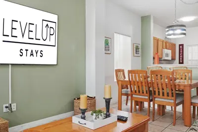 a kitchen and dining room with a table and chairs at Resort stay Pool Access Peaceful Retreat Balcony in Kissimmee