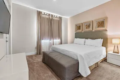 a white bedroom with a bed and a couch at Home Luxury 03 Beds Close Disney At Magic Village in Orlando