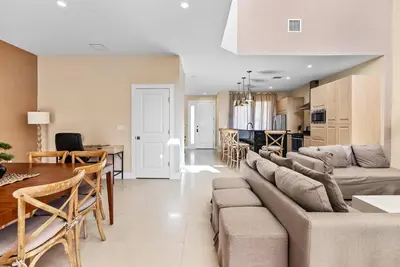 a living room and kitchen with a couch and a table at Home Luxury 03 Beds Close Disney At Magic Village in Orlando