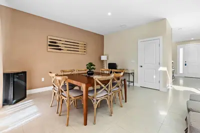 a dining room with a table and chairs at Home Luxury 03 Beds Close Disney At Magic Village in Orlando